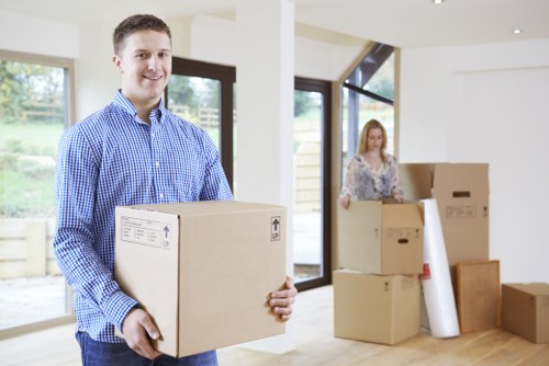 Professional removals staff transporting office furniture during a Pinner business move